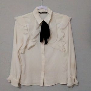 A Black and White Tie Neck Blouse